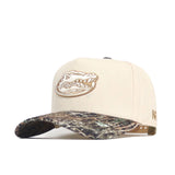 The No Rivals Florida Camo Connector Hat features a beige crown with an embroidered alligator head, a brown camo pre-curved brim, "NF" in beige on the side, and a snapback closure for a comfortable, structured fit.