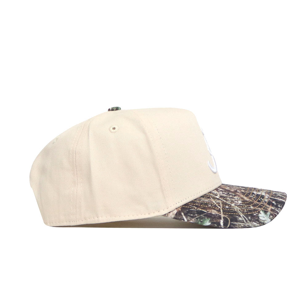 The No Rivals Alabama Camo Connector Hat is a beige snapback with a flat, camo-patterned brim, made from high quality cotton and featuring a structured fit, shown in side profile against a white background.