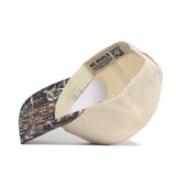 The Alabama Camo Connector Hat by No Rivals is shown upside down, displaying its NO RIVALS label and a QR code. The brim features a forest camouflage design and is made from high-quality cotton for a structured fit.