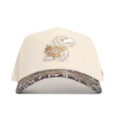 The No Rivals Kansas Camo Connector Hat features a beige crown, camouflage brim, and a brown and white KU Jayhawk logo on the front. Made from high-quality cotton with a structured fit.