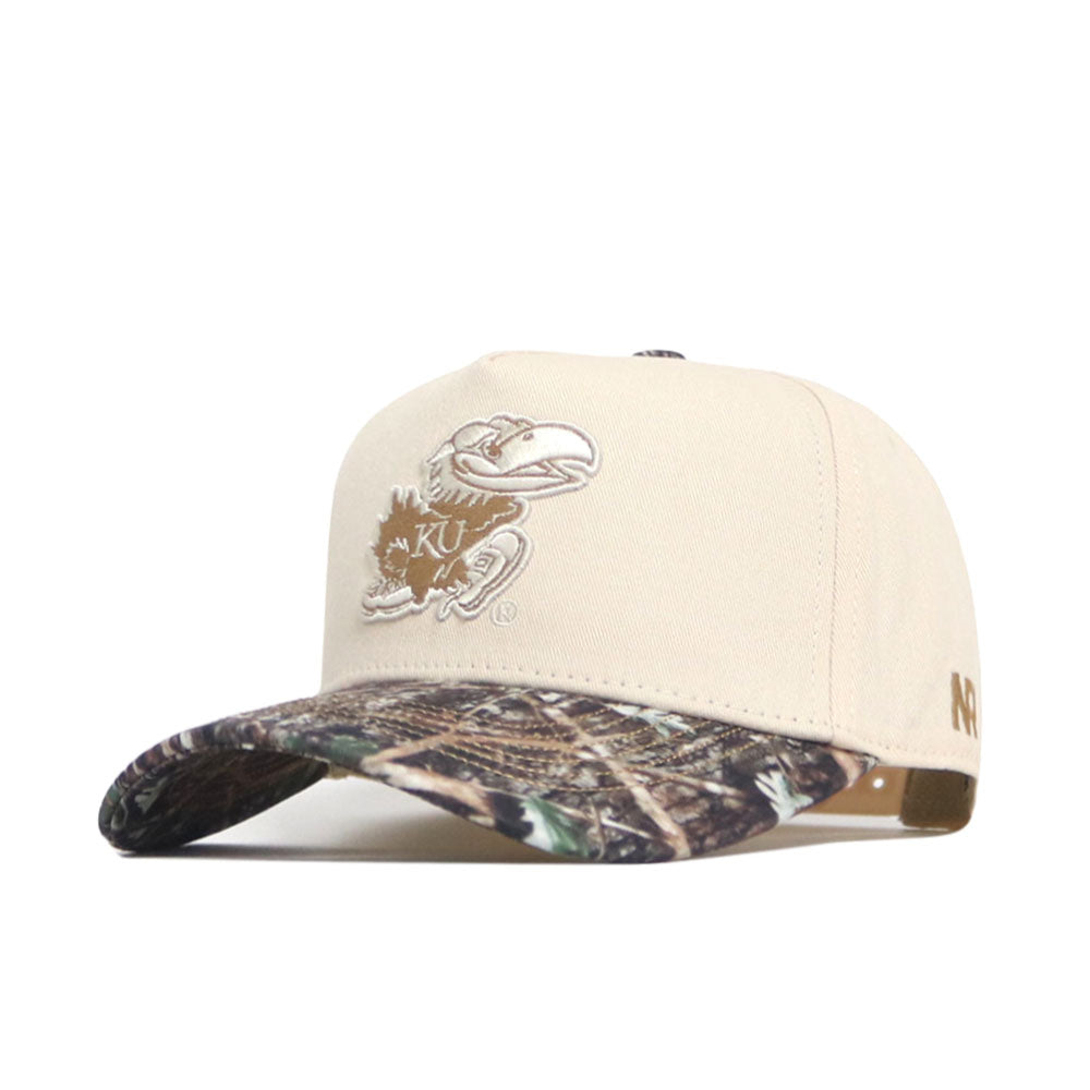 The No Rivals Kansas Camo Connector Hat features a beige crown, camo-patterned brim, and embroidered KU Jayhawk logo. Made from high-quality cotton with a structured fit and adjustable snapback closure for comfort.