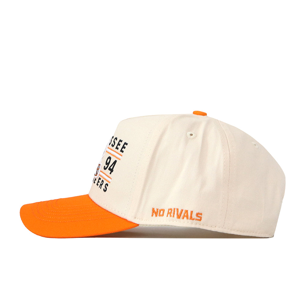 Show your game day pride with the Tennessee Football Kickoff Hat by No Rivals. This white cap features a vibrant orange brim and top button, accented by NO RIVALS embroidered in orange on the side, and bold black letters and numbers on the front. An additional embroidered logo adds a premium touch, making it the perfect finishing piece for your outfit.