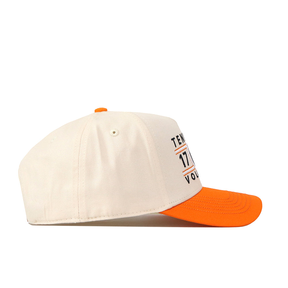 A side view of the No Rivals Tennessee Football Kickoff Hat, featuring a cream-colored snapback with an orange brim and button. The front panel displays partial text, numbers, and an embroidered logo.