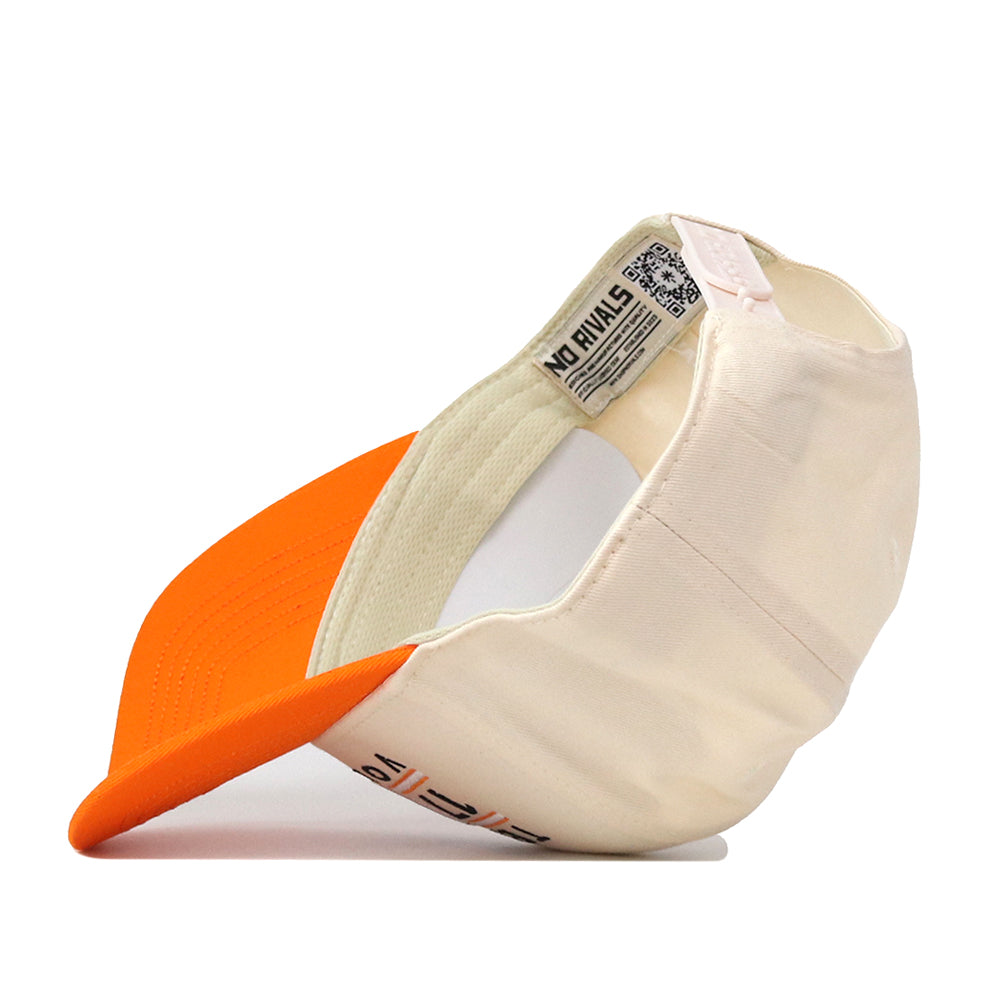 The Tennessee Football Kickoff Hat by No Rivals is shown from the side, featuring a cream and orange snapback design with the orange bill facing left. A label inside reads “No Rivals,” and an embroidered logo adds a detailed touch. The cap is displayed against a white background.