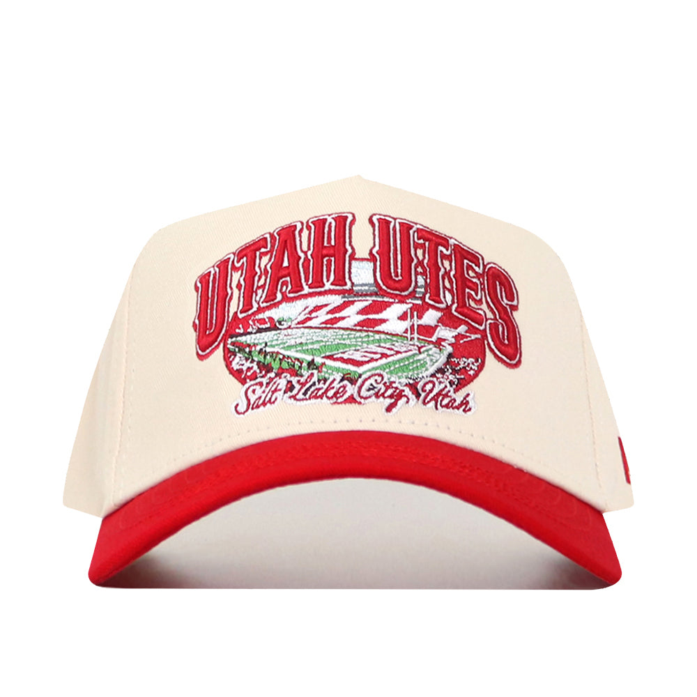 Show your team spirit with the Utah Utes Stadium Hat by No Rivals. This cream and red snapback features “Utah Utes” and “Salt Lake City, Utah” embroidered above a detailed football stadium design. As an officially licensed cap, it’s finished with intricate embroidered logos, making it a must-have for true fans.