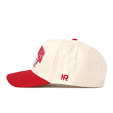 A side-profile view of the No Rivals Utah Utes Stadium Hat, featuring a cream-colored snapback design with a red brim and red NR embroidered logos on the side.