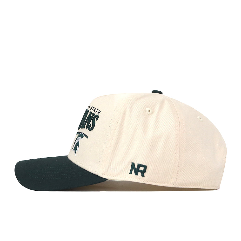 The Michigan State Spartans Stride Hat by No Rivals is a cream baseball cap with a dark green brim, crafted from high-quality cotton for comfort and durability. It features embroidered text and logo on the front, NR initials on the side, a structured fit, and an adjustable snap back closure.