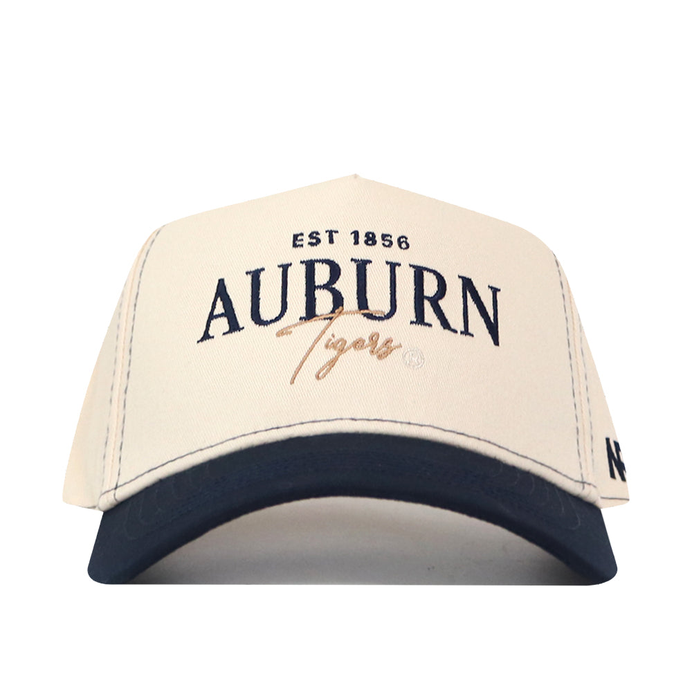 A white Auburn Tigers Vintage Hat by No Rivals featuring a navy brim. The front displays “EST 1856 AUBURN Tigers” in navy and gold text, along with an officially licensed embroidered logo.
