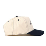 The Auburn Tigers Vintage Hat by No Rivals is a beige snapback with black stitching and a black brim, shown from the side. Two black eyelets are visible on the crown.