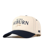 Introducing the Auburn Tigers Vintage Hat by No Rivals—a beige and navy snapback cap featuring the Auburn Tigers and EST 1856 embroidered logo on the front, with AUB letters stitched on the side. This officially licensed hat is perfect for showing off your team pride.