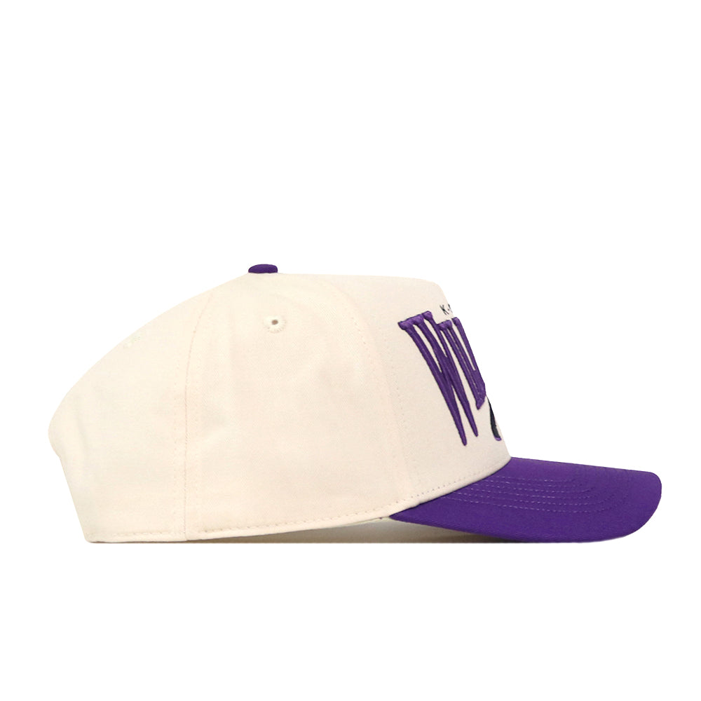 The No Rivals Kansas State Wildcats Stride Hat is a white snapback with a bold purple brim, displayed in profile view. Featuring large purple embroidered text on the front, this cap is the perfect standout piece for your next gameday fit.