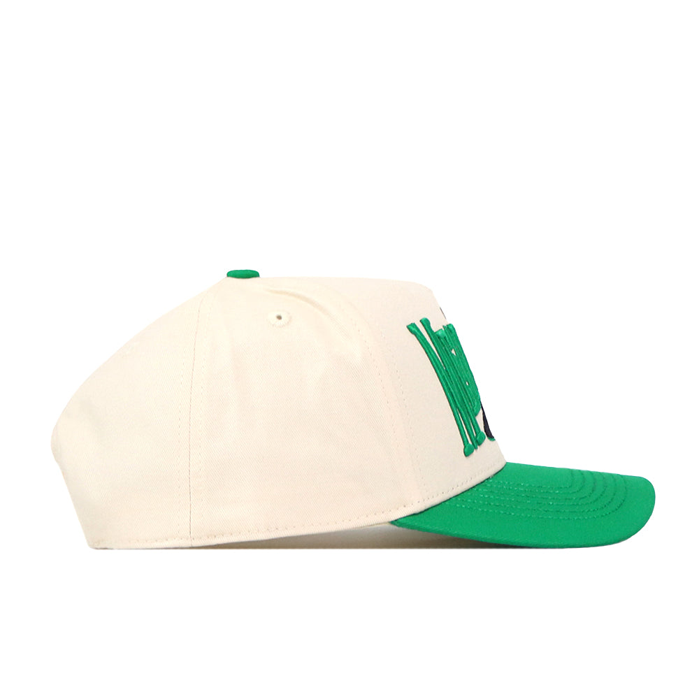 The North Texas Mean Green Stride Hat by No Rivals is a cream-colored snapback with a green brim and green embroidered logos on the front, perfect for completing your game day fit. Shown here in a left side view against a white background.