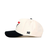 The Scheels Longhorn Hat - Black is a structured snapback baseball cap featuring black and red embroidery on the front and side, a white crown with a black brim, and crafted from high-quality cotton for a stylish look.
