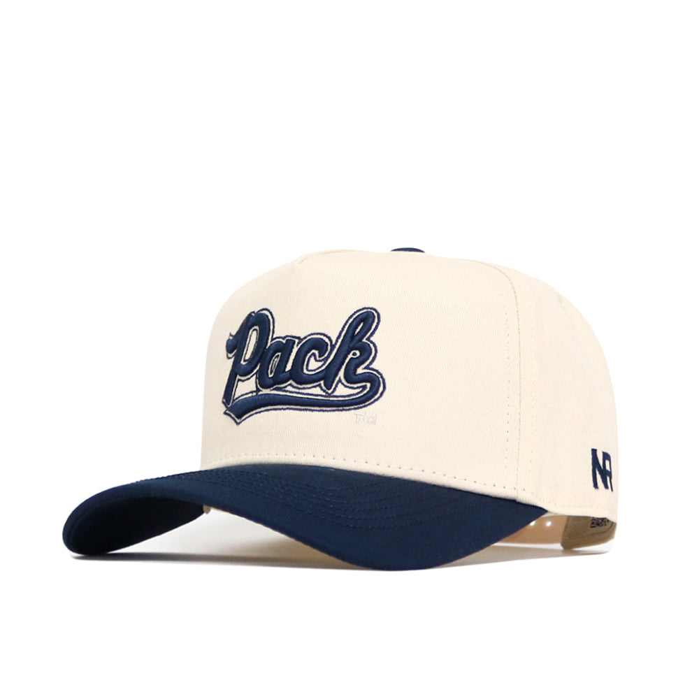 A cream snapback baseball cap with a navy brim, featuring bold 3D "Pack" embroidery on the front. The No Rivals Nevada Logo Patch Hat adds an authentic touch with its officially licensed design.