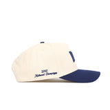 The Rice Ballpark Hat by No Rivals is a cream baseball cap with a navy bill, adjustable snap back, and blue "2003 National Champions" embroidery on the side.