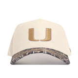 The No Rivals Miami Camo Connector Hat features a large gold U on the front, a camouflage-patterned brim, high-quality cotton construction, and an adjustable snapback closure.