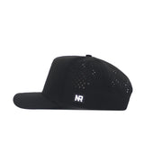 The No Rivals Vanderbilt Golf Hat - Black features a flat bill, small ventilation holes, an NR logo patch, and detailed side embroidery. Shown in side profile on a white background.