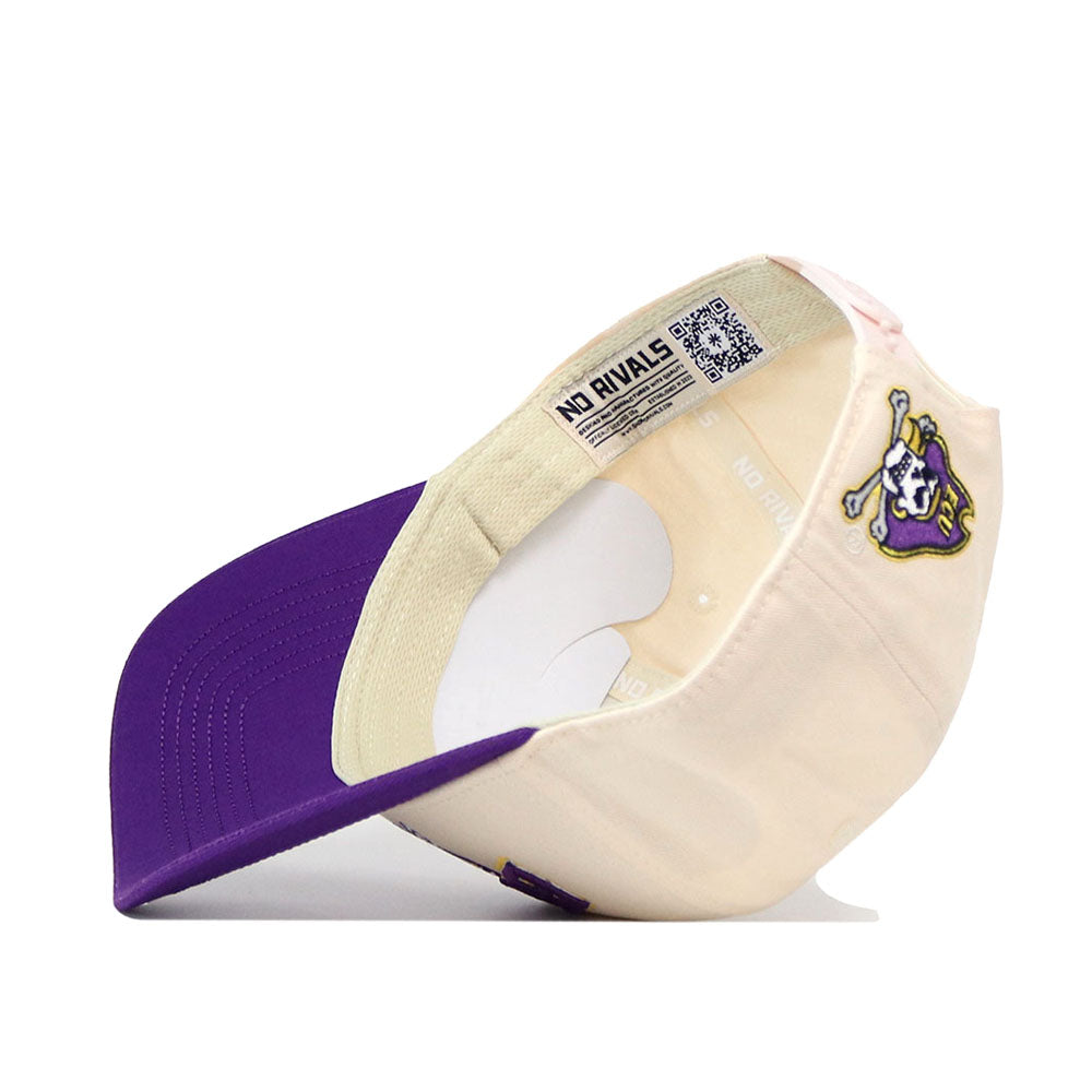 The ECU Pirates Stadium Hat by No Rivals is displayed upside down, revealing its high-quality cotton construction and an inside label reading "NO RIVALS." This structured cap features a beige main body with a purple brim and displays a pirate mascot logo on the side. It is designed to maintain its shape over time and comes equipped with a convenient snap back closure for an adjustable fit.