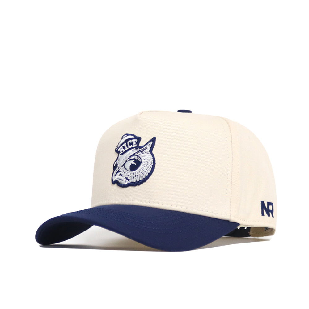 The Rice Sammy Sailor Patch Hat by No Rivals is a cream snapback cap with navy brim, featuring an embroidered owl head and RICE on the front, plus NR stitched on the side.