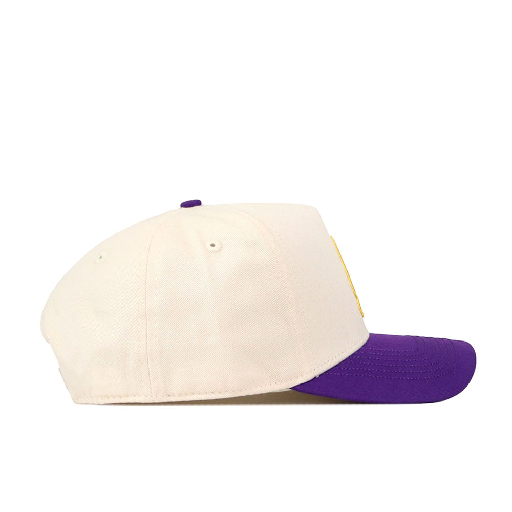The No Rivals ECU Pirates Halftime Hat features a cream-colored crown, a purple brim, and eye-catching embroidered logos. Shown in a side view on a white background, this snapback is perfect for elevating your next gameday fit.