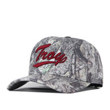 Introducing the No Rivals Troy Outland Hat—a camouflage baseball cap showcasing an embroidered “Trap” logo in bold red script across the front, complete with a snapback closure for a customizable fit.