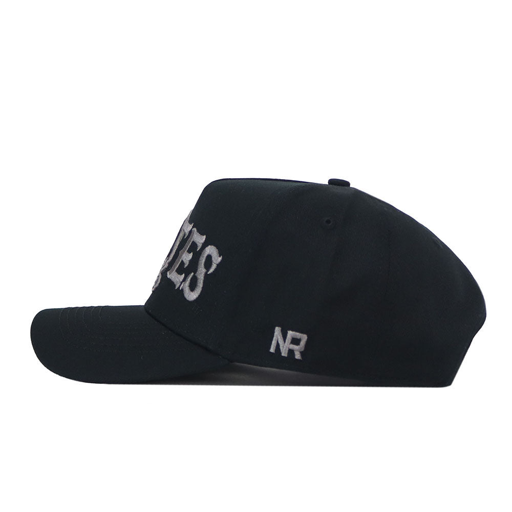 A side view of the ECU Pirates Night Mode Hat by No Rivals, crafted from high-quality cotton. This structured snapback features bold white embroidered letters partially visible on the front and the initials "NR" stitched in white on the side, combining lasting comfort with standout style.