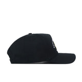 The No Rivals ECU Pirates Outlaw Hat in black is displayed laying flat on a white background, shown in a side profile view with the brim facing right. A small portion of the embroidered logo is visible on the front.