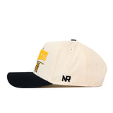 The Kennesaw State Stride Hat by No Rivals is a cream-colored baseball cap with a black brim, featuring a yellow and black embroidered logo on the front and “NR” stitched in black on the side. This officially licensed snapback is shown from the side against a white background.