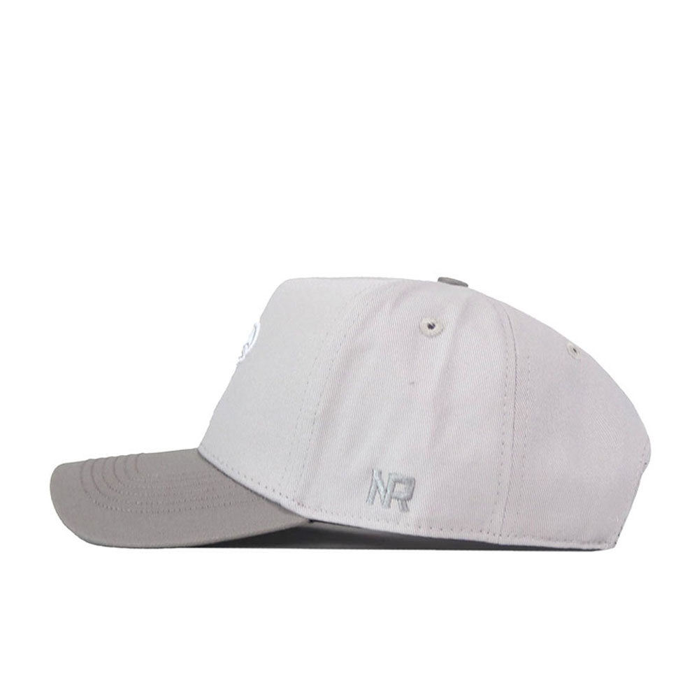 A No Rivals Kansas Jayhawks Graphite Hat featuring a light gray color, snapback closure, and a slightly curved brim, is displayed in side profile with the small, officially licensed NR embroidered logo on the side against a white background.