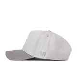 A No Rivals Kansas Jayhawks Graphite Hat featuring a light gray color, snapback closure, and a slightly curved brim, is displayed in side profile with the small, officially licensed NR embroidered logo on the side against a white background.