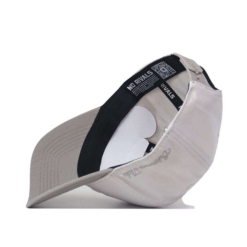 A Kansas Jayhawks Graphite Hat by No Rivals flipped upside down, revealing the inside lining, black sweatband with NO RIVALS text and a QR code, along with an adjustable strap.