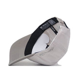 A Kansas Jayhawks Graphite Hat by No Rivals flipped upside down, revealing the inside lining, black sweatband with NO RIVALS text and a QR code, along with an adjustable strap.