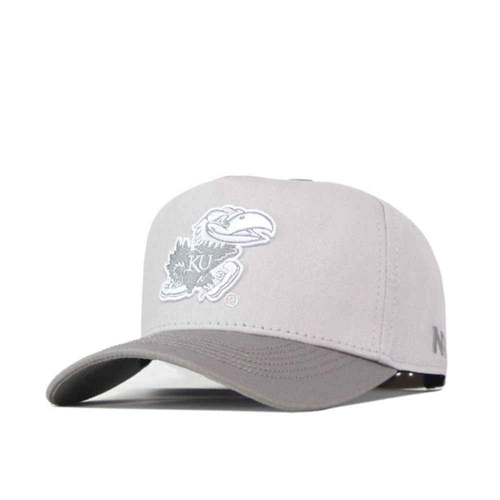 Introducing the Kansas Jayhawks Graphite Hat by No Rivals—a light gray snapback cap showcasing an officially licensed, embroidered white Jayhawk logo with “KU” on the front and a small “N” on the brim’s side.