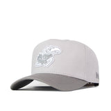 Introducing the Kansas Jayhawks Graphite Hat by No Rivals—a light gray snapback cap showcasing an officially licensed, embroidered white Jayhawk logo with “KU” on the front and a small “N” on the brim’s side.