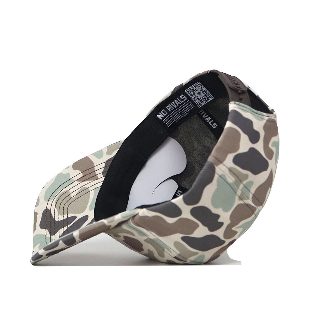 The ECU Pirates Huntsman Hat by No Rivals, featuring a 5-panel design in Duck Camo, is shown upside down to reveal its black inner band, product tags, and a white insert inside the hat.