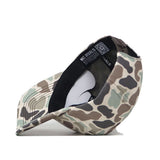 The ECU Pirates Huntsman Hat by No Rivals, featuring a 5-panel design in Duck Camo, is shown upside down to reveal its black inner band, product tags, and a white insert inside the hat.