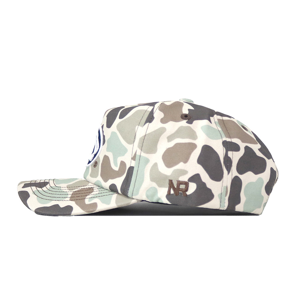 A side view of the Penn State Nittany Lions Huntsman Hat by No Rivals, featuring a camouflage pattern and structured snapback design crafted from high quality cotton. The hat is adorned with an NB logo embroidered in brown thread on the side, offering a durable and modern accessory for everyday wear.