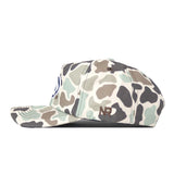 A side view of the Penn State Nittany Lions Huntsman Hat by No Rivals, featuring a camouflage pattern and structured snapback design crafted from high quality cotton. The hat is adorned with an NB logo embroidered in brown thread on the side, offering a durable and modern accessory for everyday wear.