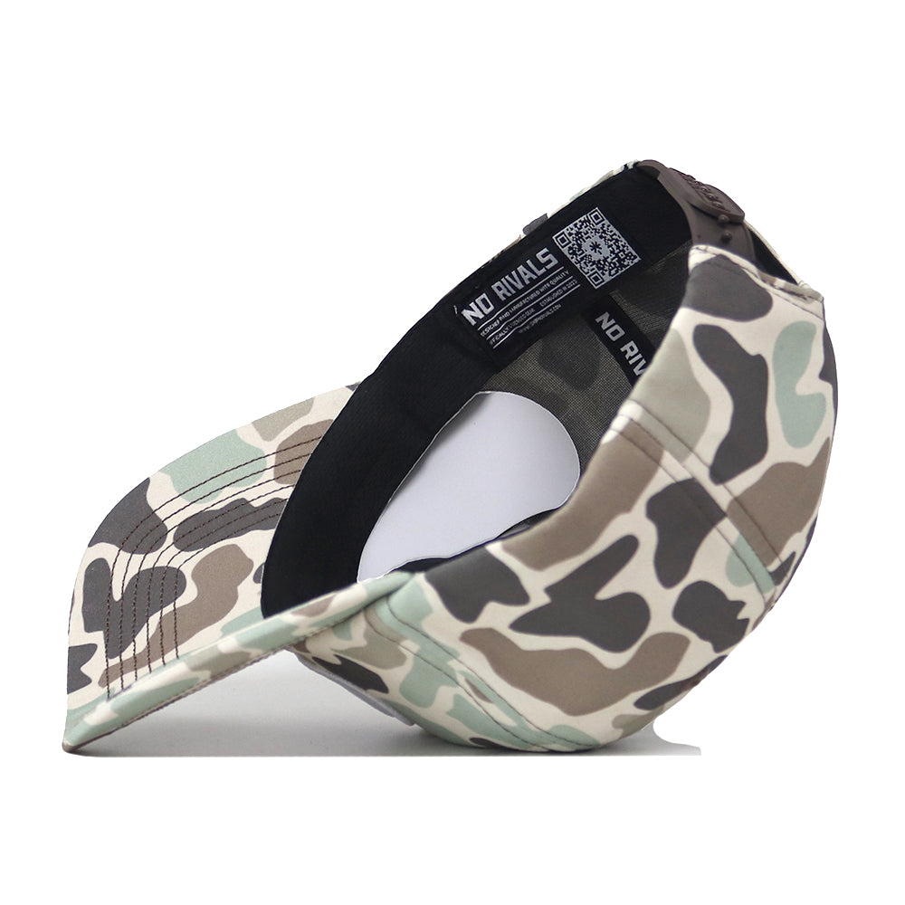 The Penn State Nittany Lions Huntsman Hat by No Rivals is a structured fit snapback featuring a camo pattern in green, brown, and beige tones. When turned inside out, it reveals the inner black band, detailed stitching, and a NO RIVALS label with a QR code. Expertly crafted from high-quality cotton.