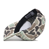 The Penn State Nittany Lions Huntsman Hat by No Rivals is a structured fit snapback featuring a camo pattern in green, brown, and beige tones. When turned inside out, it reveals the inner black band, detailed stitching, and a NO RIVALS label with a QR code. Expertly crafted from high-quality cotton.