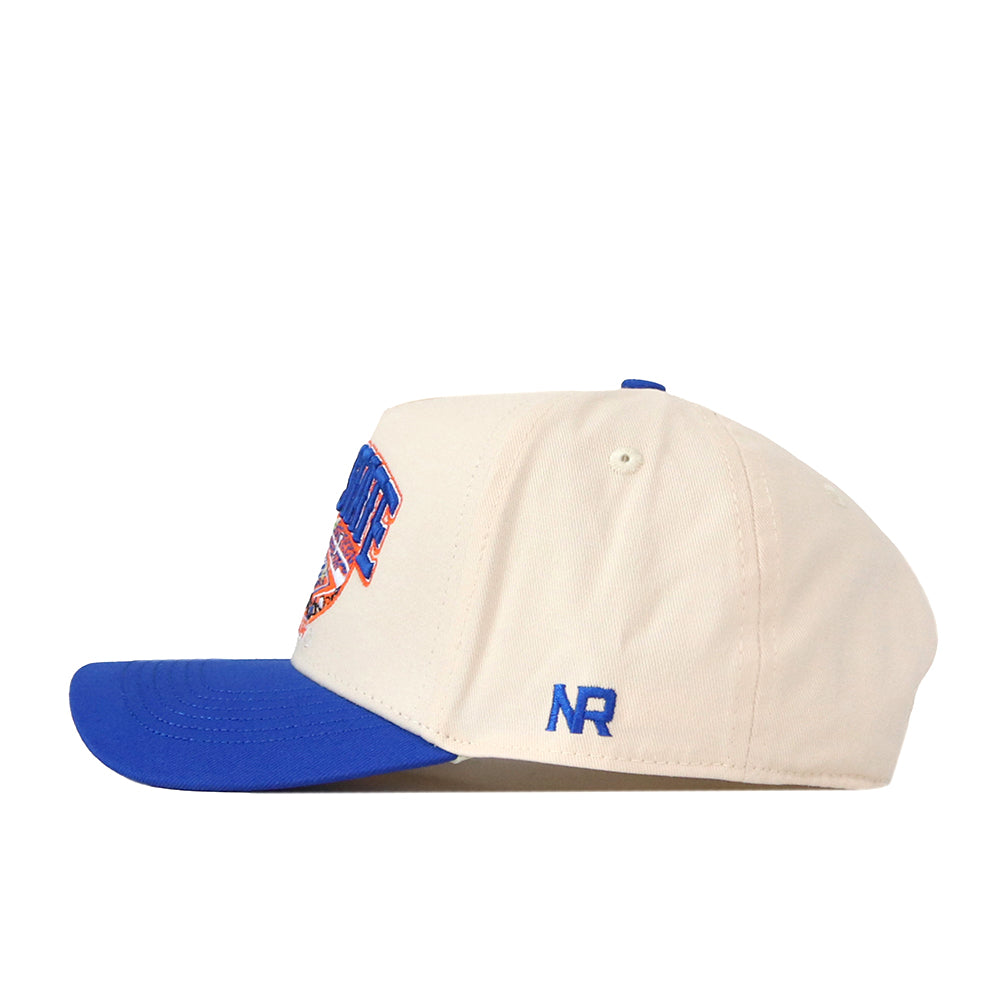 The Boise State Broncos Stadium Hat by No Rivals features a cream-colored snapback design with a blue brim, blue embroidered “NR” letters on the side, and a vibrant multicolored patch partially visible on the front—perfect for adding a sporty touch to your gameday outfit.