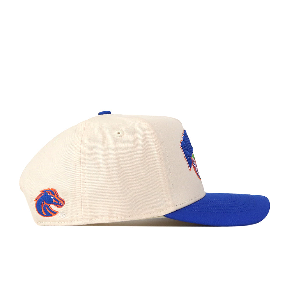 Side view of the Boise State Broncos Stadium Hat by No Rivals—a cream-colored snapback featuring a blue brim and an embroidered blue and orange bronco logo on the side, perfect for completing your gameday fit.