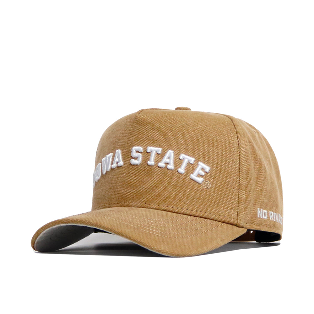 The Iowa State Rustic Hat by No Rivals is a tan cotton canvas cap with IOWA STATE embroidered in white on the front and NO RIVALS on the visor. This structured snapback is shown on a white background.