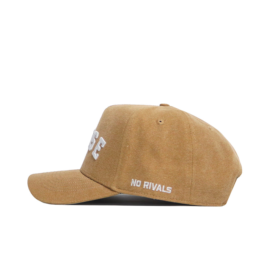 The Boise State Rustic Hat by No Rivals is a brown cotton canvas snapback cap with white embroidered "NO RIVALS" text above the brim and part of a larger white word on the front, shown in profile on a white background.