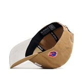 The No Rivals Boise State Rustic Hat, in tan cotton canvas, is displayed upside down to reveal a black inner band labeled NO RIVALS and a small blue and red eagle logo embroidered on the side.