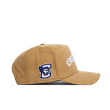 The No Rivals Creighton Rustic Hat is a tan cotton canvas baseball cap with "CREIGHTON" in white on the front and a blue jay logo with a "C" on the side. This officially licensed snapback is shown from the left side.