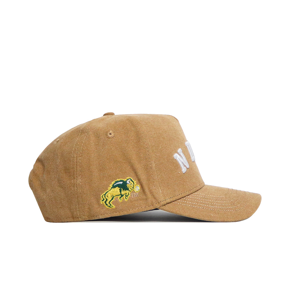 The No Rivals NDSU Rustic Hat is a brown cotton canvas baseball cap featuring white embroidered letters on the front and a yellow and green bison logo on the side, shown in a side view.