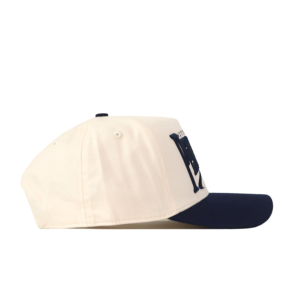 The No Rivals Penn State Nittany Lions Stride Hat is displayed from the side on a plain white background, showcasing its structured fit, white crown, navy blue brim, and bold navy blue lettering on the front.