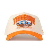 The No Rivals Tennessee Volunteers Neyland Checkard Hat is a cream and orange snapback featuring embroidered “TENNESSEE VOLS” and “Neyland Stadium” text above a detailed football stadium graphic, finished with an embroidered logo—perfect for topping off your gameday look.