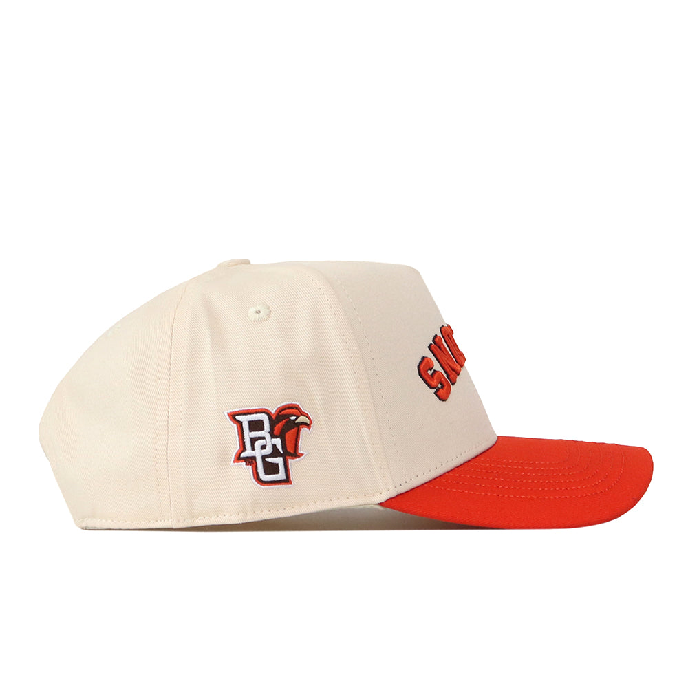 No Rivals’ Bowling Green State Falcons | Upside Down Falcons Hat - Classic Colors is a cream-colored snapback baseball cap with a red brim. The side displays a BG logo with a falcon head, representing the Bowling Green State Falcons, while orange text appears on the front (partially visible from the side view).